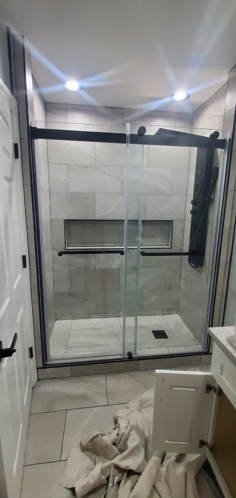Finished master bathroom tiling and custom hardware finishes